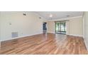 Open-concept living room featuring vaulted ceilings, wood flooring and lots of natural light at 541 Wekiva River Ct # 94, Englewood, FL 34223