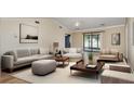 Bright and spacious living room with comfortable seating and sliding glass doors to the outdoors at 541 Wekiva River Ct # 94, Englewood, FL 34223