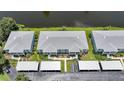 Aerial view of condo buildings with lush green surroundings near canal at 5725 Greenwood Ave # 2101, North Port, FL 34287