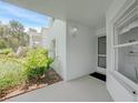Inviting entryway with white walls, exterior lighting, and lush landscaping at 5725 Greenwood Ave # 2101, North Port, FL 34287