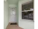 Close-up of the front door and window, offering a glimpse of the interior and natural light at 5725 Greenwood Ave # 8203, North Port, FL 34287