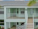 Charming condo exterior showcasing the building number and a well-maintained facade with easy access stairway at 5725 Greenwood Ave # 8203, North Port, FL 34287
