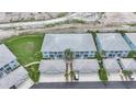 Aerial view of blue condos with metal roofs and attached garages at 5762 Sabal Trace Dr # 203, North Port, FL 34287