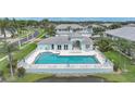 A beautiful in-ground community pool surrounded by lush landscaping at 5762 Sabal Trace Dr # 203, North Port, FL 34287