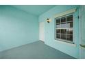 Covered porch features blue walls, gray floor, and an exterior light fixture at 5762 Sabal Trace Dr # 203, North Port, FL 34287