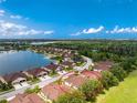 Aerial view features a community near a body of water with lush landscaping and serene surroundings at 8866 Tuscany Isles Dr, Punta Gorda, FL 33950