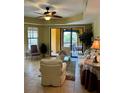 Comfortable living room with ample seating, tile floors, and a sliding glass door that opens to a balcony at 96 Vivante Blvd # 9622, Punta Gorda, FL 33950