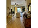 Inviting living room featuring neutral tones, tile flooring, and a sliding glass door leading to a private balcony at 96 Vivante Blvd # 9622, Punta Gorda, FL 33950