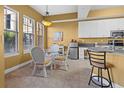 Sunny breakfast nook with white chairs, glass top table, and bright windows, offering lovely views at 99 Vivante Blvd # 310, Punta Gorda, FL 33950
