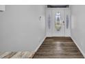 Bright, open foyer with wood-look flooring and a decorative front door at 1210 Mccrory St, North Port, FL 34286