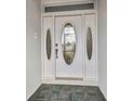 Close up of the front door, featuring decorative glass and panels at 1210 Mccrory St, North Port, FL 34286