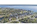 Stunning aerial view of waterfront homes along canal leading to bay with lush greenery and docks at 12299 Albrecht Ter, Port Charlotte, FL 33981