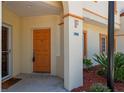 Inviting entry with a vibrant door, decorative accents, and manicured landscaping at 1236 Rio De Janeiro Ave # 406, Punta Gorda, FL 33983