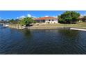 Waterfront home boasting a private dock, lush greenery, and screened in patio at 1318 San Mateo Dr, Punta Gorda, FL 33950