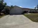 A well-maintained single-story home boasts a spacious driveway and two-car garage at 1318 San Mateo Dr, Punta Gorda, FL 33950