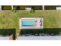 Aerial view of a sparkling pool surrounded by lush landscaping, with lounge chairs for relaxing at 1348 Rock Dove Ct # C201, Punta Gorda, FL 33950