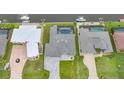 Aerial view of waterfront homes, showcasing backyard pools and boat docks on a sunny day at 15148 Taurus Cir, Port Charlotte, FL 33981