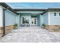 Inviting front entrance with seating area and stone accents, creating a warm welcome at 15148 Taurus Cir, Port Charlotte, FL 33981