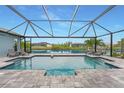 Screened-in pool and deck overlooking a canal with waterfront views in a relaxing setting at 15148 Taurus Cir, Port Charlotte, FL 33981