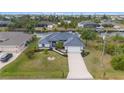 Beautiful waterfront home featuring mature trees, well-maintained landscaping and a long driveway at 15890 Viscount Cir, Port Charlotte, FL 33981