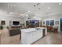Modern kitchen features an island with white cabinets and stainless steel appliances in an open concept layout at 1932 Los Alamos Dr, Punta Gorda, FL 33950