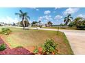Spacious front yard with a view of a quiet street and glimpses of waterfront scenery at 2028 River Basin Ter, Punta Gorda, FL 33982