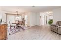 Bright dining area with hardwood floors, a chandelier, and an adjacent living area at 2365 Nuremberg Blvd, Punta Gorda, FL 33983