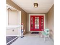 Inviting front porch features double red doors and a decorative patriotic statue at 2365 Nuremberg Blvd, Punta Gorda, FL 33983