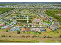 An aerial view showcases the home's location within a tranquil neighborhood with serene ponds and lush green spaces at 2747 Suncoast Lakes Blvd, Punta Gorda, FL 33980