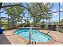 Relaxing screened-in lanai featuring a rejuvenating spa, perfect for unwinding amidst a private outdoor setting at 2747 Suncoast Lakes Blvd, Punta Gorda, FL 33980