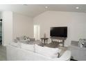Inviting living room featuring modern furniture, a TV, and ample space for relaxing and entertaining at 2858 Parlay Ln, North Port, FL 34286