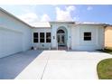 Charming coastal home featuring a light blue exterior with white trim and an arched entry at 3772 Peace River Dr, Punta Gorda, FL 33983