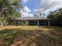 Home's rear exterior showing the screened in patio and large yard at 4205 Simkins Ave, North Port, FL 34286