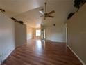 A spacious living room features gleaming hardwood floors and a stylish ceiling fan at 4205 Simkins Ave, North Port, FL 34286