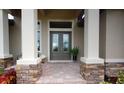 Elegant front entrance featuring a double door, stone accents, columns and tiled entryway at 4426 Vasco St, Punta Gorda, FL 33950