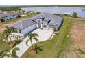 An elevated view of a luxury home boasting manicured grounds and waterfront views at 5061 Collingswood Blvd, Port Charlotte, FL 33948