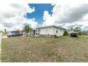 Charming single-story home featuring a well-maintained lawn and a clean exterior, with ample parking space in the driveway at 6103 Fabian Rd, North Port, FL 34287