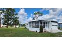 This home has a sunroom and a well-maintained lawn, offering a tranquil outdoor space at 6843 Amoko Ct, North Port, FL 34287