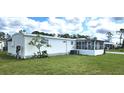 The home features a sunroom and a well-maintained lawn, offering a tranquil outdoor space at 6843 Amoko Ct, North Port, FL 34287