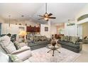 Inviting living room with comfortable seating, neutral tones, and an open layout into the dining and kitchen areas at 7101 Dogwood Ct, North Port, FL 34287