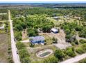 Expansive aerial view of the property showing the house, pond, surrounding land and wooded areas at 7274 Alan Blvd, Punta Gorda, FL 33982