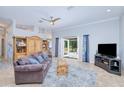 Comfortable living room with tile floors, ceiling fan and French doors leading to outdoor area at 7274 Alan Blvd, Punta Gorda, FL 33982