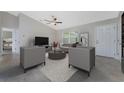 Cozy living room with modern furniture, ceiling fan, and plenty of natural light at 8687 Lisa Blvd, North Port, FL 34288