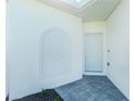 Exterior entrance featuring a white door with sidelight and neutral color scheme at 8700 Seasalt Loop, Englewood, FL 34224