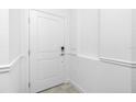 Interior entrance showcasing a white door, adjacent switch and electrical outlet at 8700 Seasalt Loop, Englewood, FL 34224