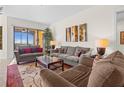 Spacious living room offers comfortable seating, stylish decor, and access to the outdoors at 99 Vivante Blvd # 303, Punta Gorda, FL 33950