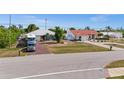 Charming single-story home with ample parking and a well-manicured lawn at 10229 Gulfstream Blvd, Englewood, FL 34224