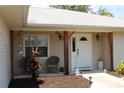 Inviting front porch featuring a decorative garden and a welcoming entrance to the home at 11422 2Nd Ave, Punta Gorda, FL 33955