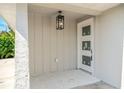 Cozy covered front porch with modern lighting and a freshly painted front door with glass inserts at 1231 Beacon Dr, Port Charlotte, FL 33952