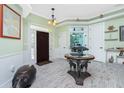Welcoming foyer with a decorative table, unique flooring, and elegant lighting fixtures at 13204 Kakapo Ave, Port Charlotte, FL 33981